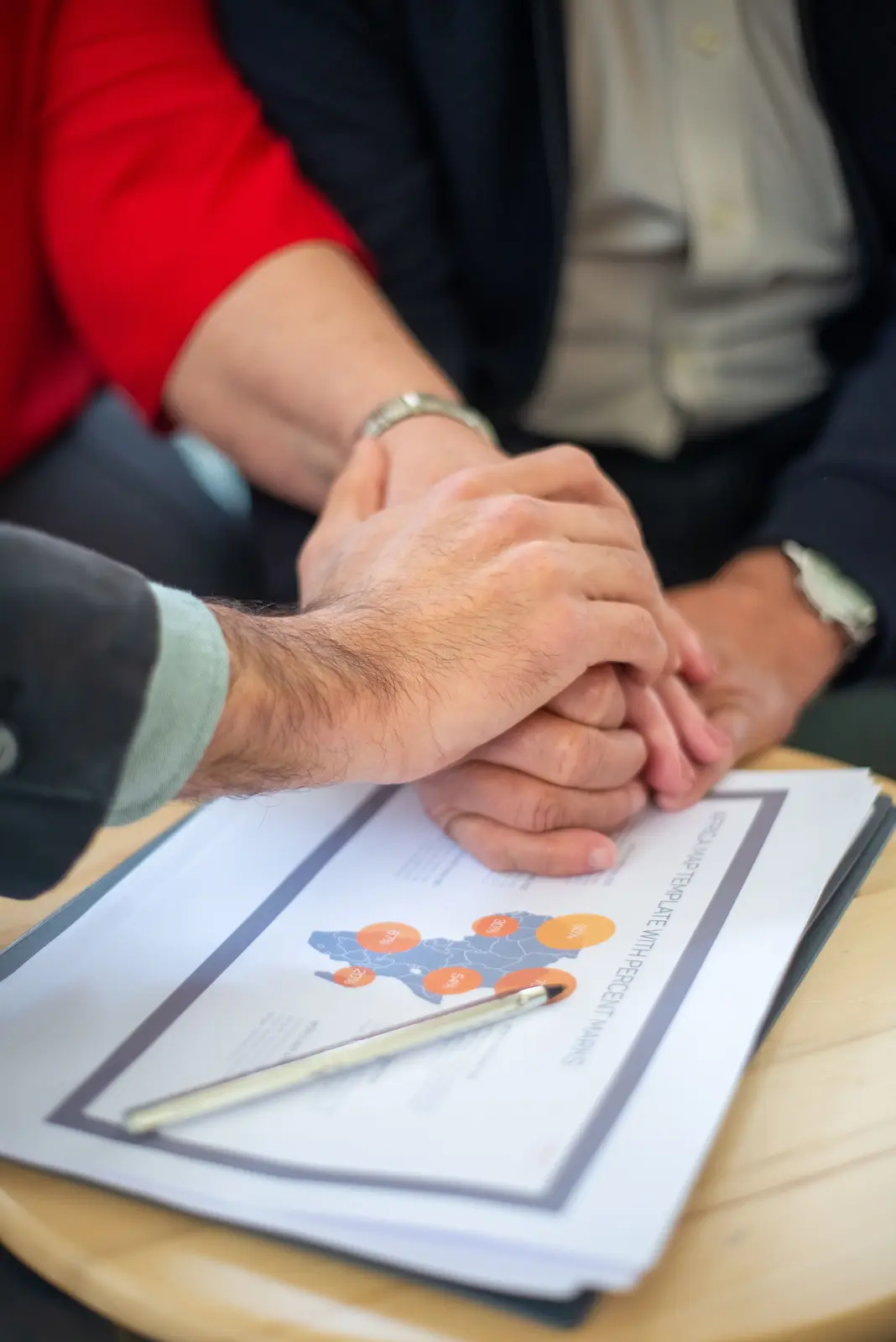 Joined hands above a file