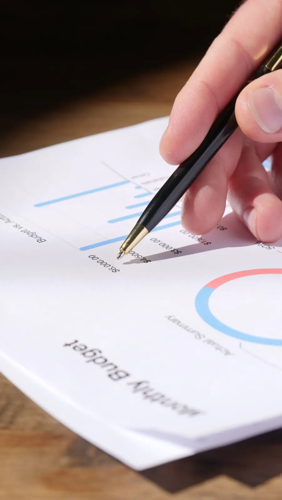 Pen pointing at a monthly budget